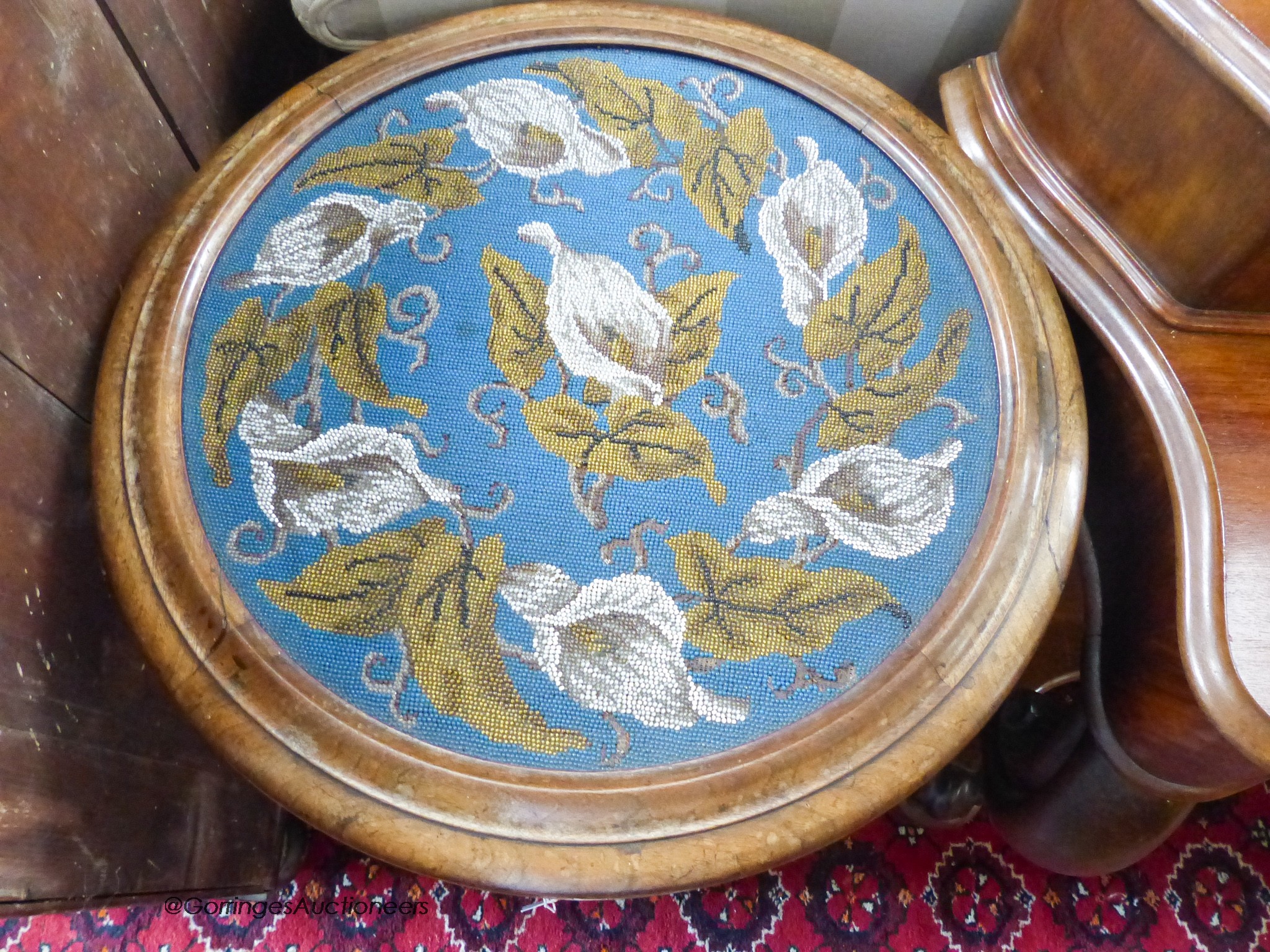 A Victorian walnut work table with circular hinged beadwork top. D-56, H-75cm.